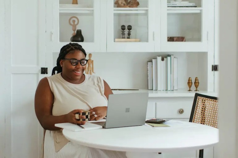 black woman on computer doing a digital declutter to organize her life